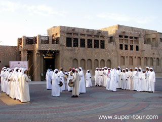 Photo: Dancers in national dress performing in front of Sheikh Saeed's House on Dubai Creek which today houses a rare collection of historic photographs, coins, stamps and documents that record Dubai's history